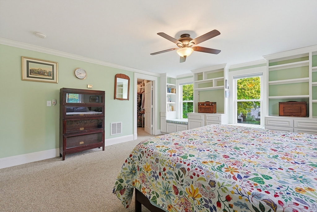 24 Riverside Place Walpole, MA 02081 - Photo 19 of 39 a bedroom with a bed and a flat screen tv