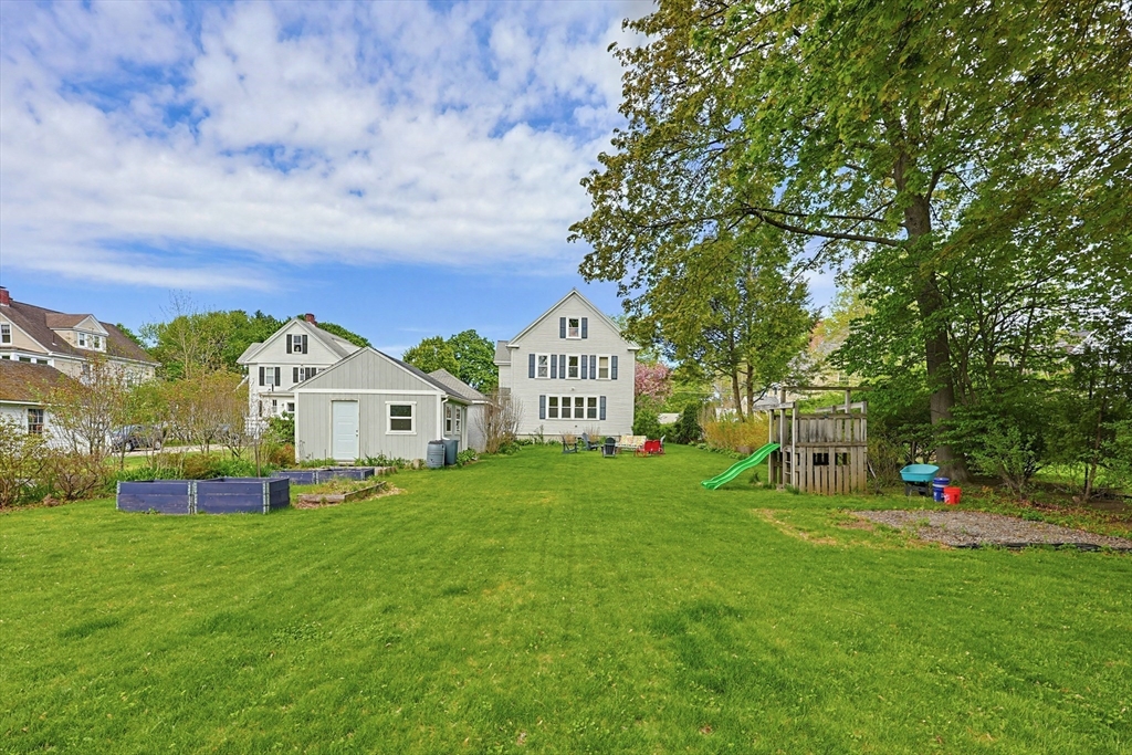 24 Riverside Place Walpole, MA 02081 - Photo 2 of 39 a view of a house with a big yard and large trees