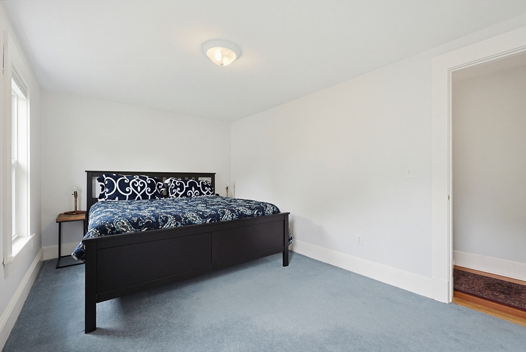 24 Riverside Place Walpole, MA 02081 - Photo 22 of 39 a bed sitting in a bedroom next to a window