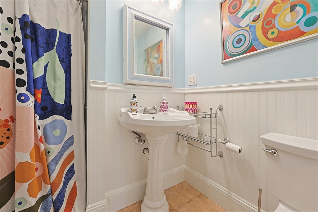 24 Riverside Place Walpole, MA 02081 - Photo 25 of 39 a bathroom with a sink and mirror with toilet