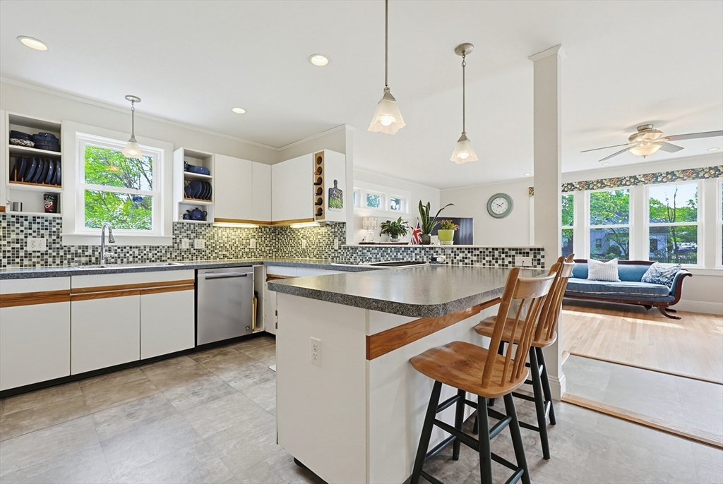 24 Riverside Place Walpole, MA 02081 - Photo 8 of 39 a kitchen with a dining table chairs sink and cabinets