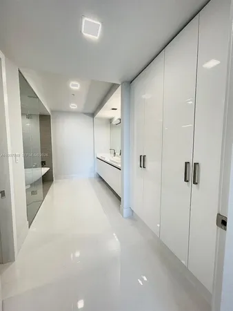 a view of a hallway with a bathroom