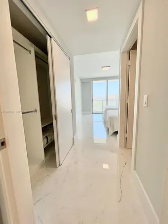 a view of a hallway to rooms and stairs