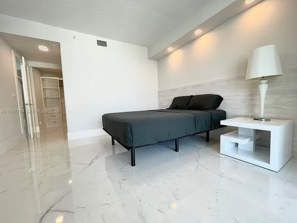 a living room with furniture and a lamp