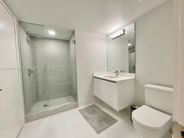 a bathroom with a toilet sink and shower