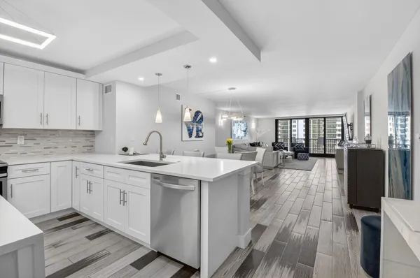 a open kitchen with stainless steel appliances granite countertop a lot of counter space and wooden floors