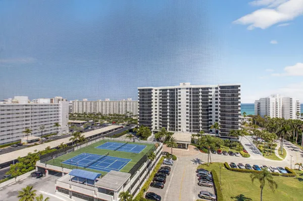 a front view of a building with outdoor space and swimming pool