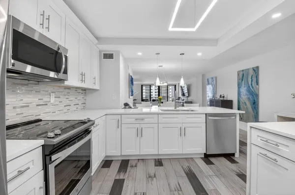 a kitchen with a sink stove and microwave