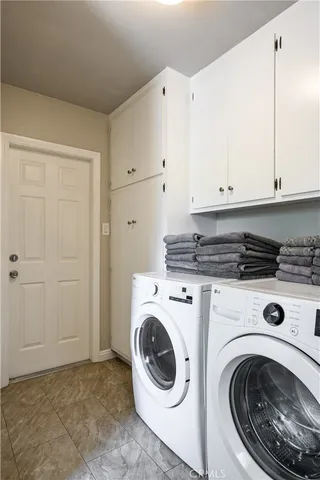 a view of a storage and utility room with washer and dryer