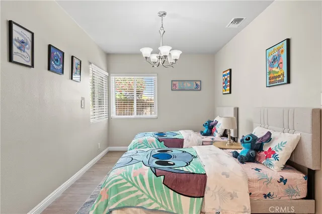 a bedroom with furniture and a chandelier