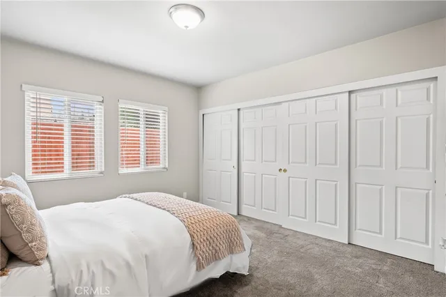 a spacious bedroom with a bed and a window