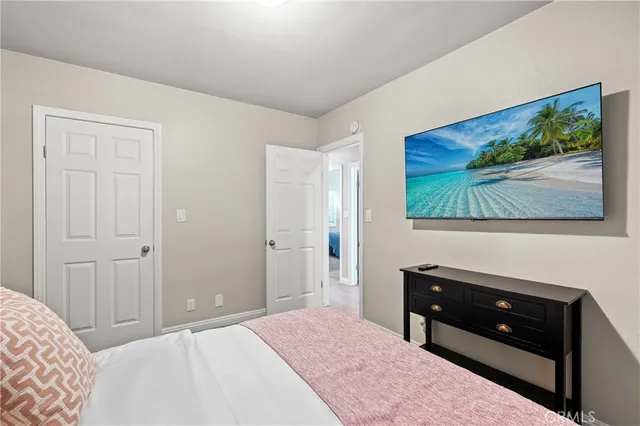 a bedroom with a bed and a flat screen tv