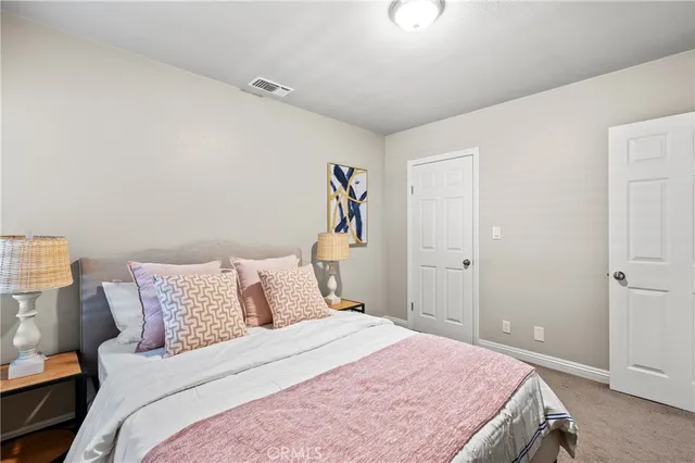 a bedroom with a bed and a painting on the wall