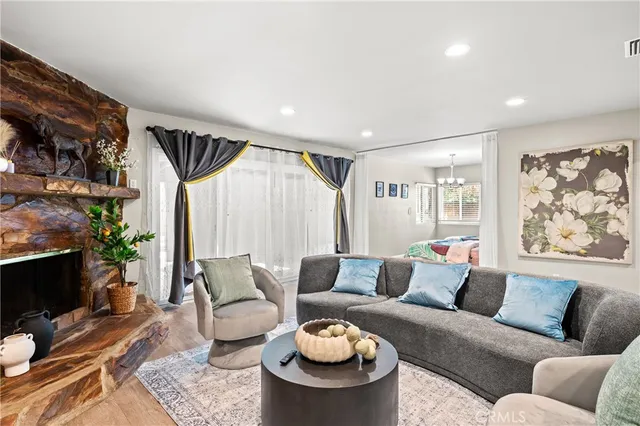 a living room with furniture a flat screen tv and a fireplace