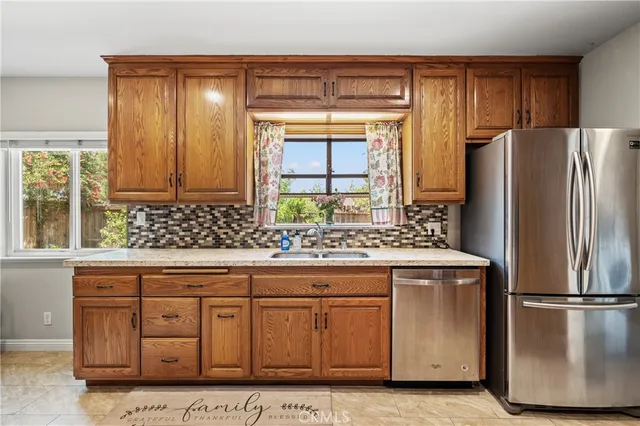 a kitchen with stainless steel appliances a refrigerator and a sink