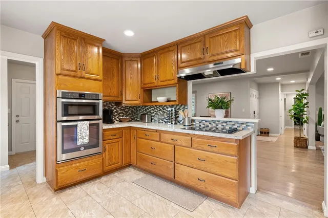 a kitchen with stainless steel appliances granite countertop a stove and cabinets