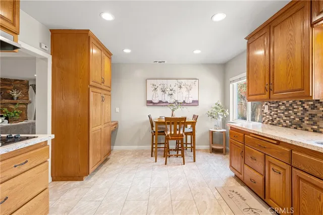 a kitchen with stainless steel appliances granite countertop a refrigerator and cabinets