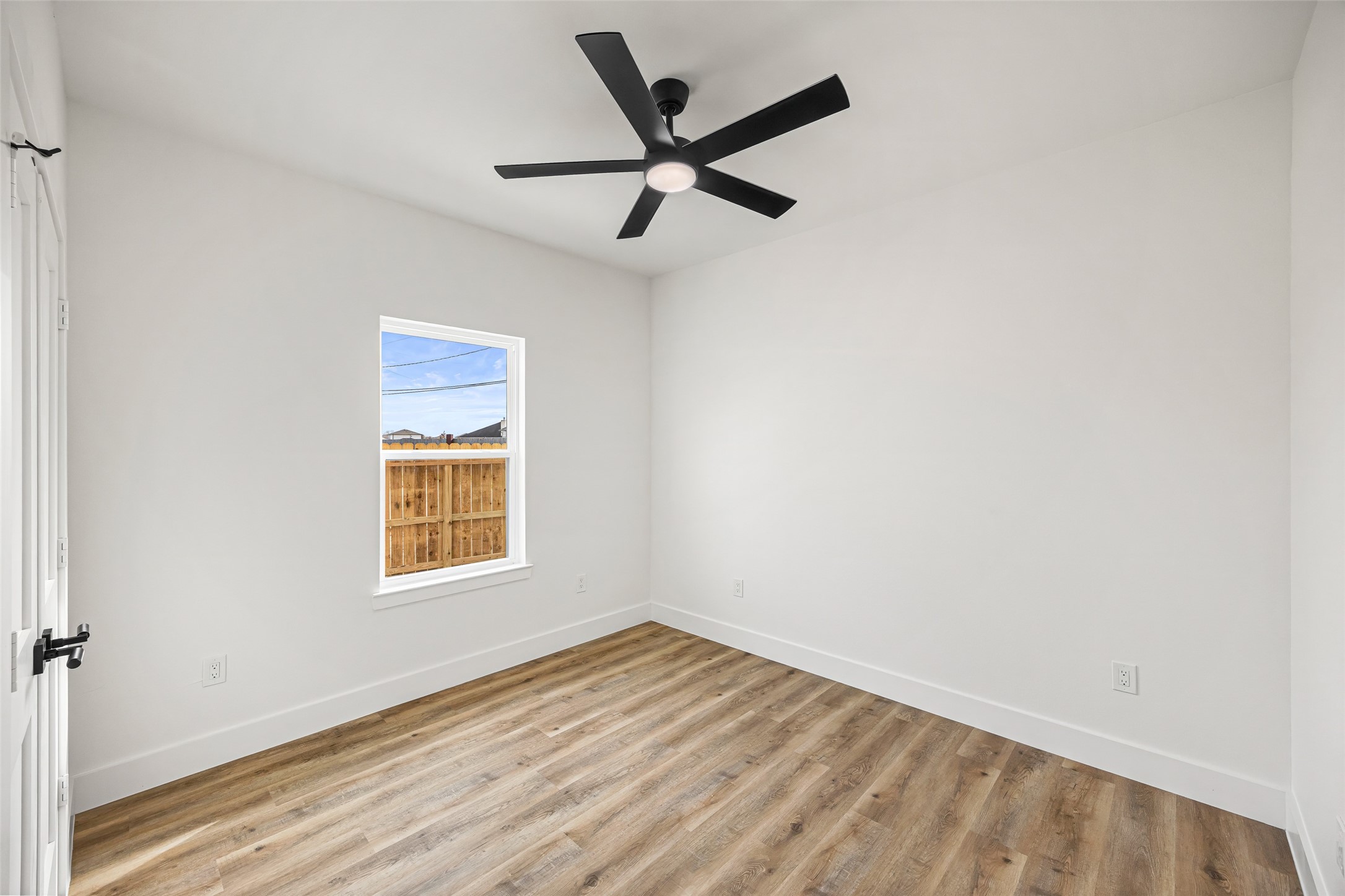 1807 Waco Street Dayton, TX 77535 - Photo 19 of 26 Comfortable bedroom with ceiling fan and backyard views.