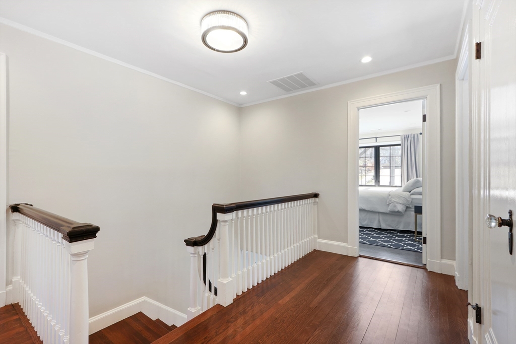 26 Greylock Road Newton, MA 02465 - Photo 15 of 28 a view of hallway with stairs and wooden floor