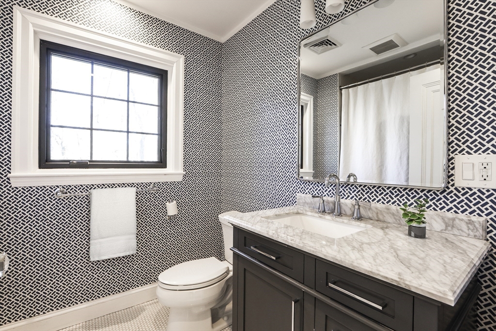 26 Greylock Road Newton, MA 02465 - Photo 20 of 28 a bathroom with a granite countertop sink a toilet and a window