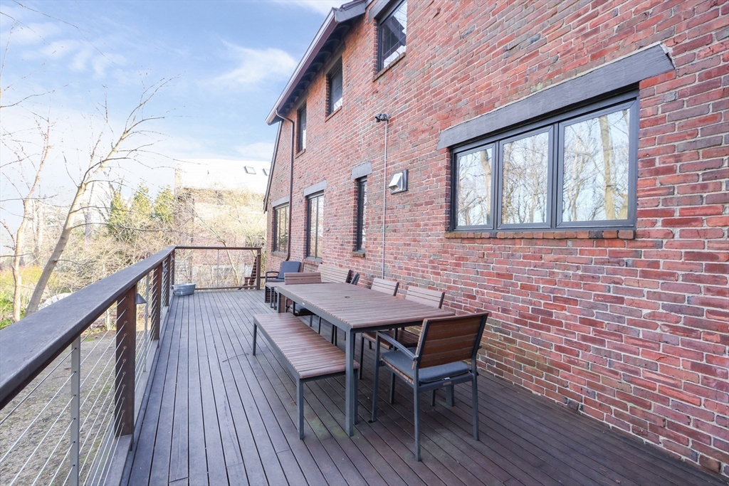 26 Greylock Road Newton, MA 02465 - Photo 25 of 28 a balcony with wooden floor table and chairs