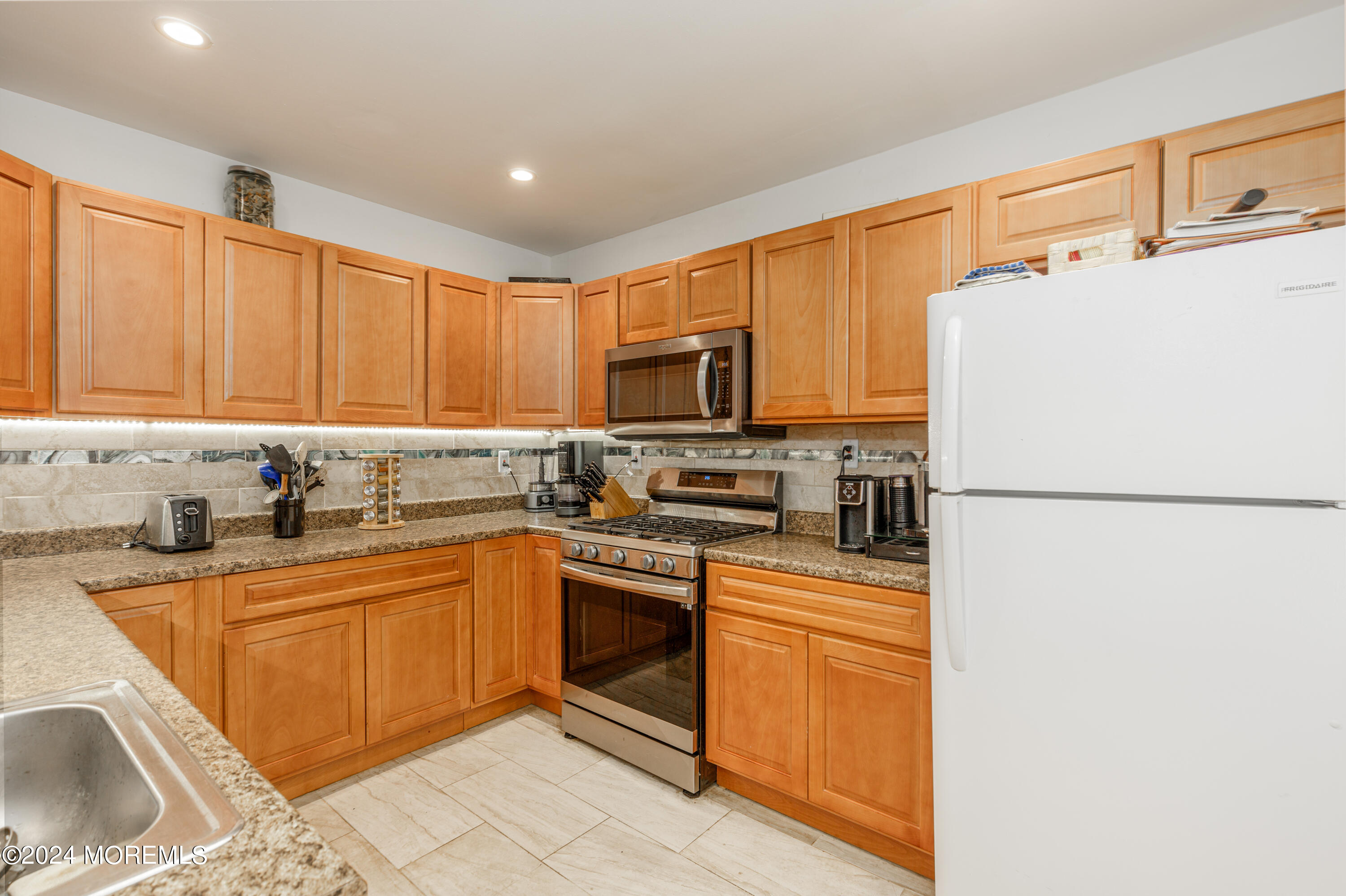 16 Boundary Road Marlboro, NJ 07746 - Photo 13 of 28 a kitchen with granite countertop a sink stainless steel appliances and cabinets