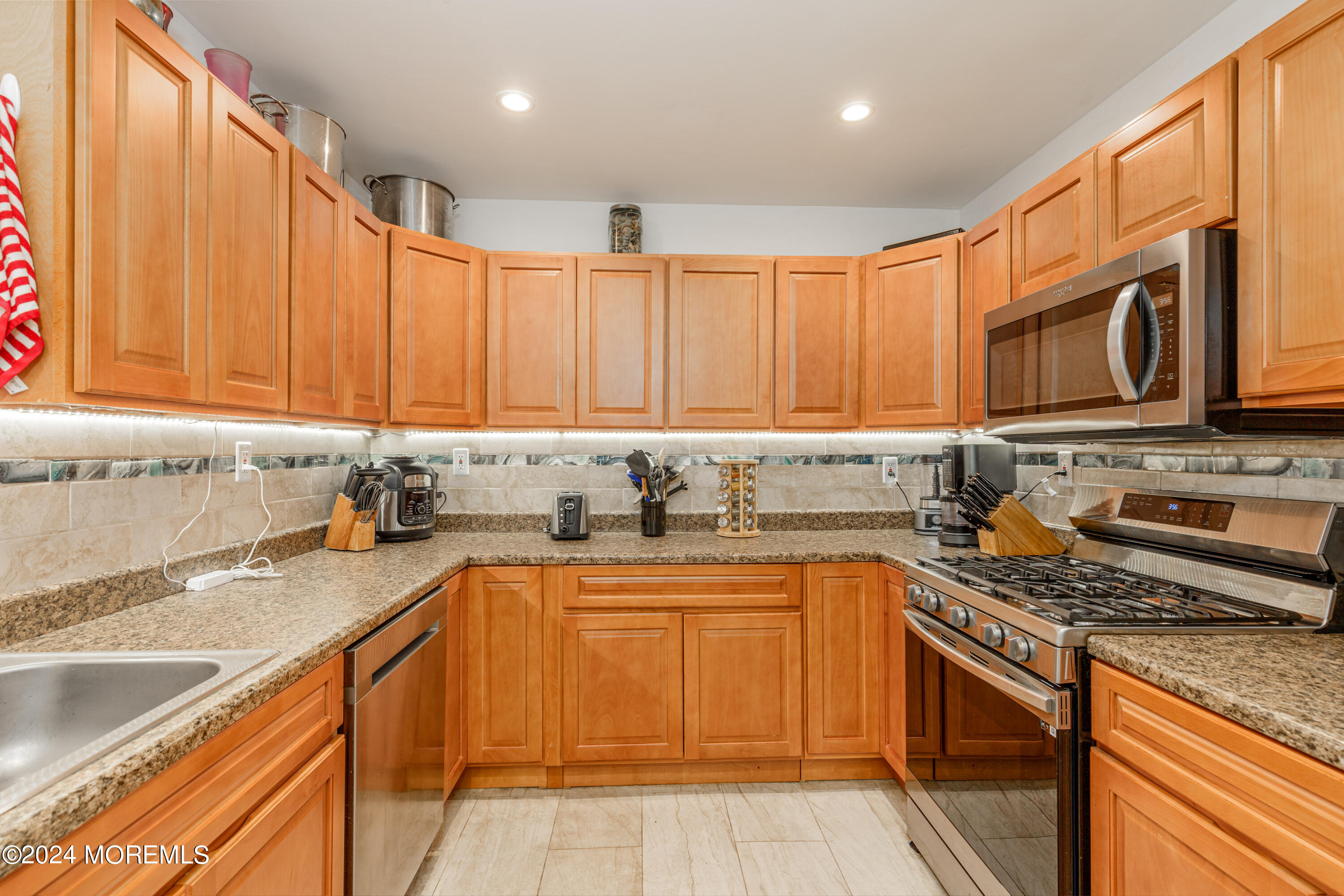 16 Boundary Road Marlboro, NJ 07746 - Photo 14 of 28 a kitchen with stainless steel appliances granite countertop a sink stove and cabinets