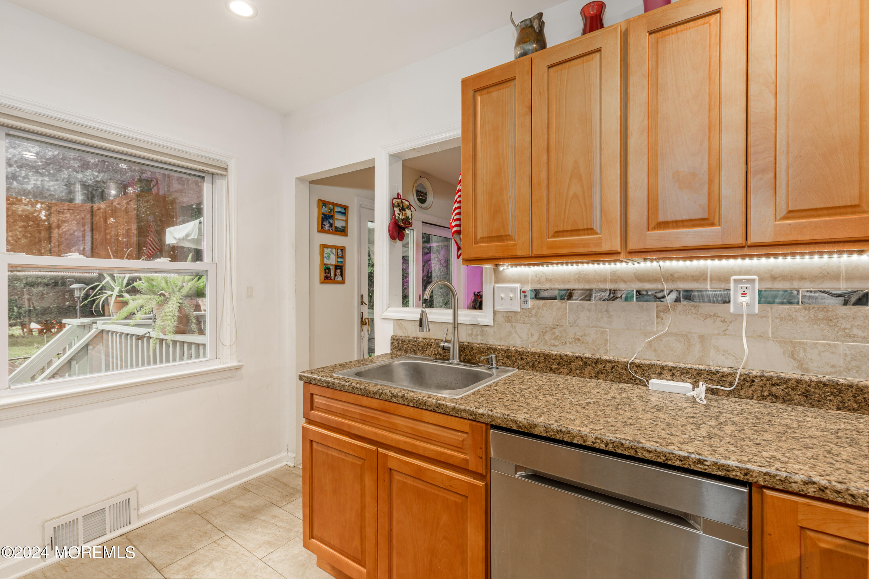 16 Boundary Road Marlboro, NJ 07746 - Photo 15 of 28 a kitchen with granite countertop a sink and dishwasher with wooden floor