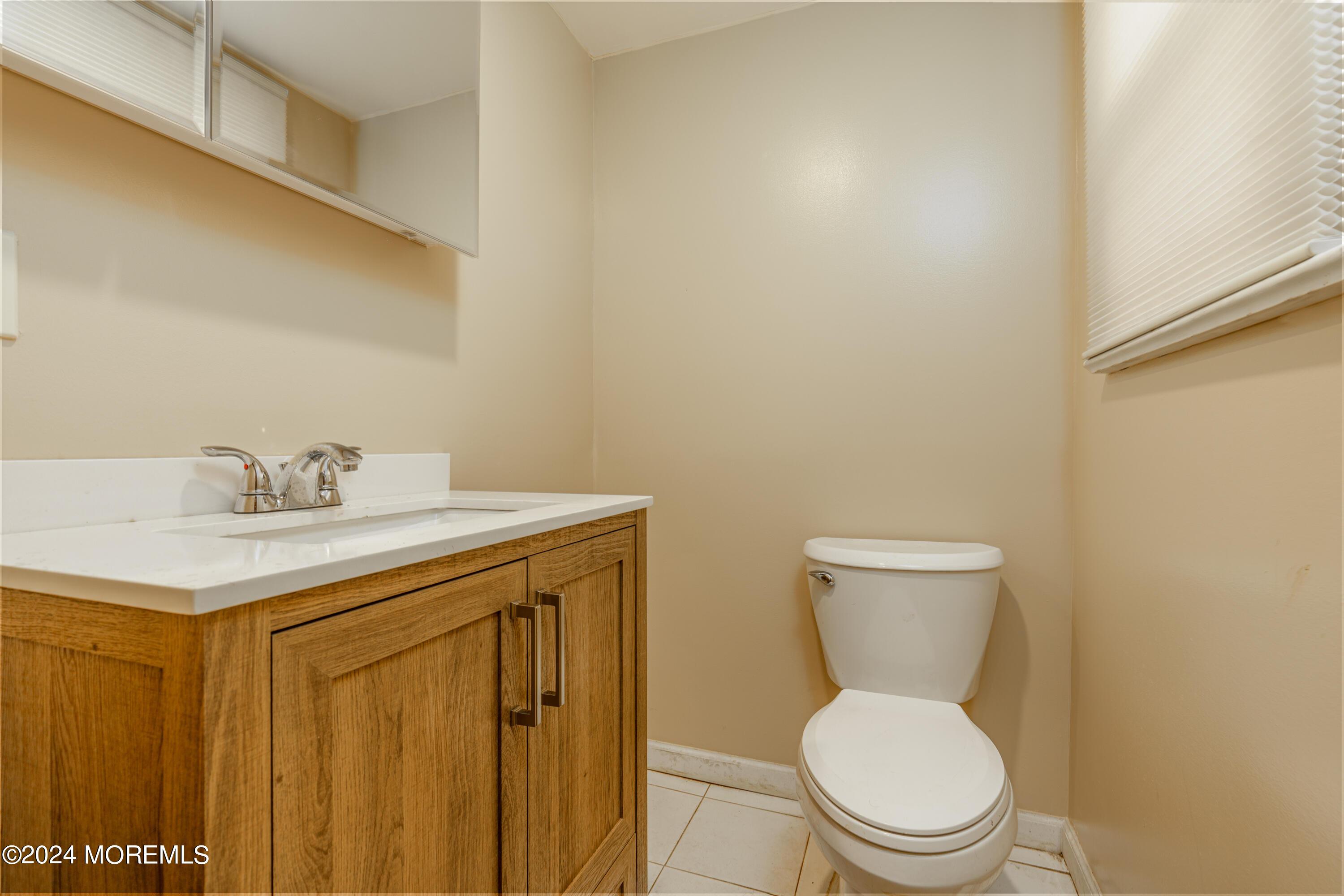 16 Boundary Road Marlboro, NJ 07746 - Photo 7 of 28 a bathroom with a toilet a sink and mirror