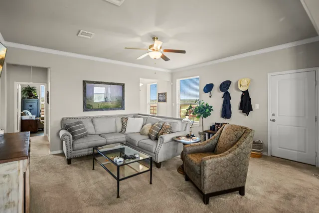 a living room with furniture and a chandelier