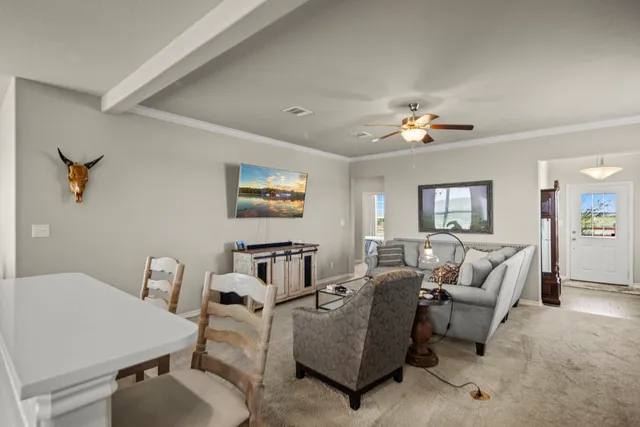 a living room with furniture and a chandelier