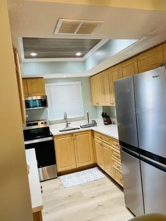 a kitchen with stainless steel appliances a refrigerator and a stove top oven