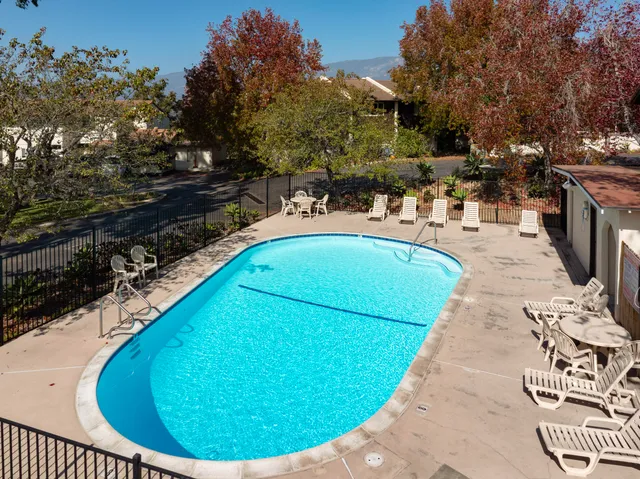 a view of a swimming pool with outdoor seating
