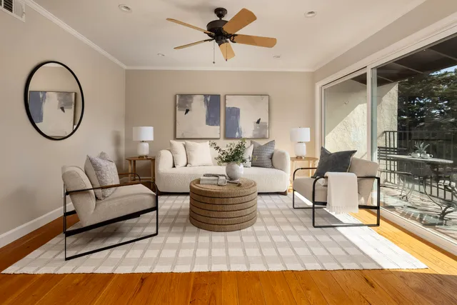 a living room with furniture a table and a potted plant