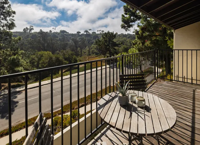 a view of a balcony with wooden floor
