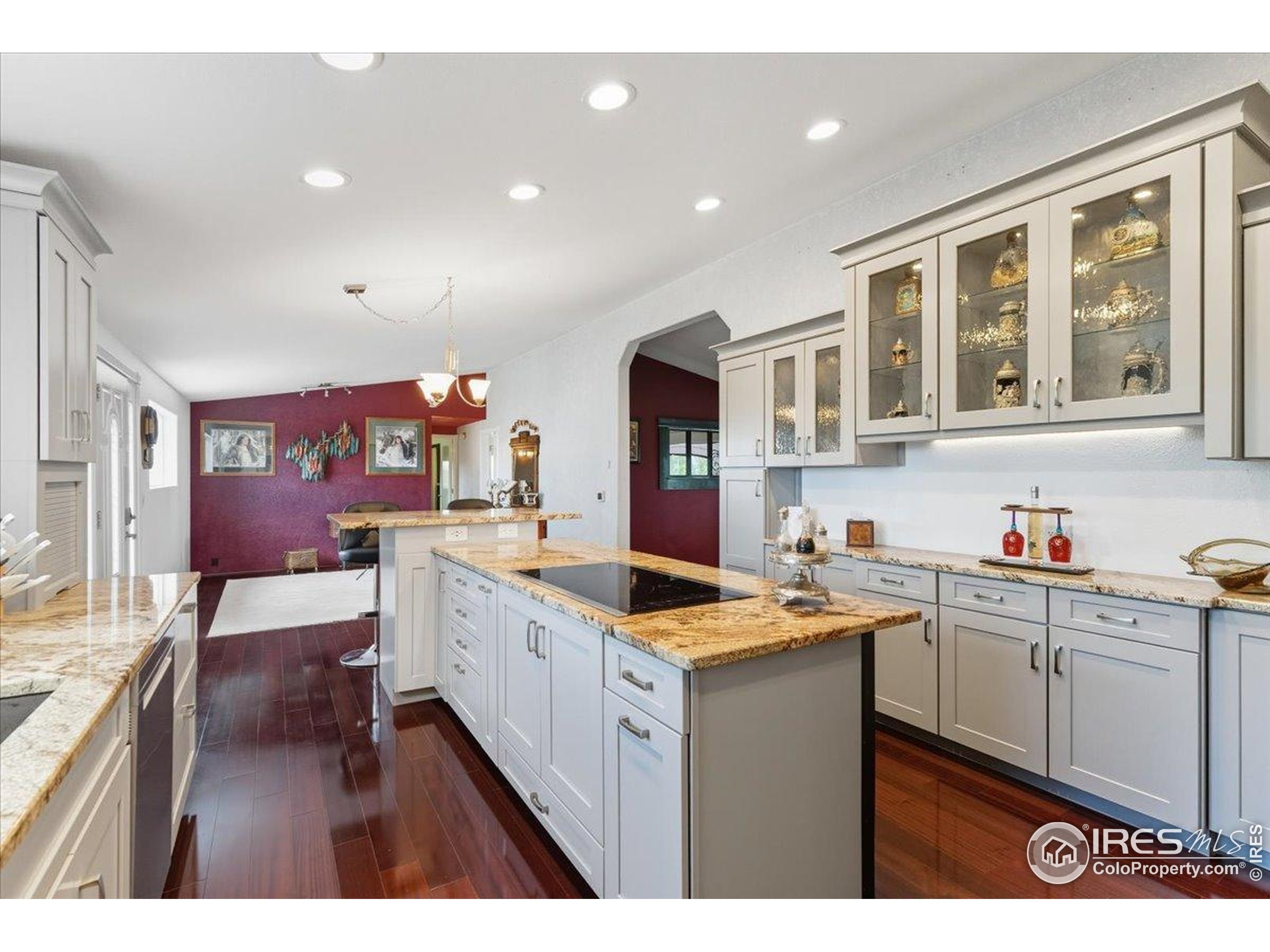 7133 North Co Road 19 Fort Collins, CO 80524 - Photo 14 of 50 a kitchen that has a lot of cabinets in it and wooden floors