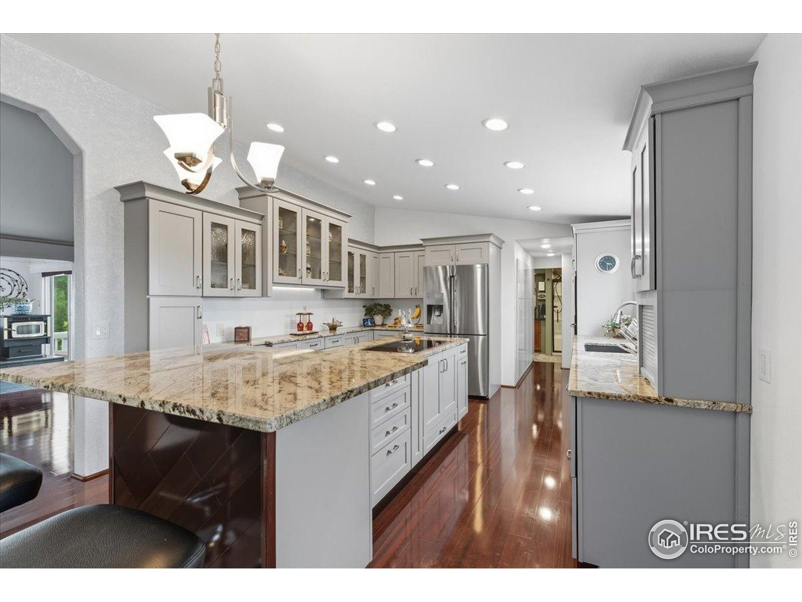 7133 North Co Road 19 Fort Collins, CO 80524 - Photo 15 of 50 a kitchen with kitchen island granite countertop a sink cabinets and stainless steel appliances