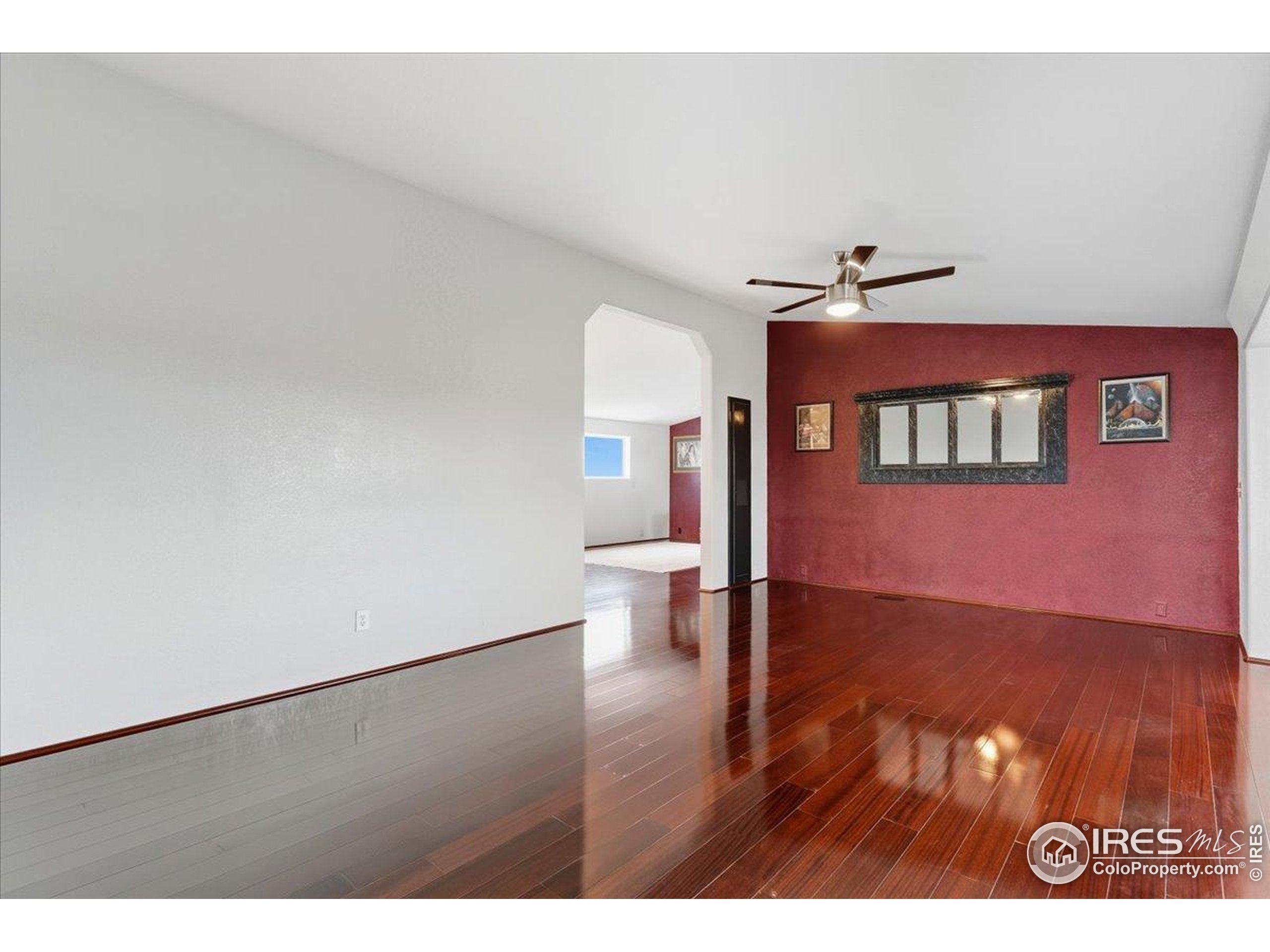7133 North Co Road 19 Fort Collins, CO 80524 - Photo 23 of 50 a view of an empty room with wooden floor