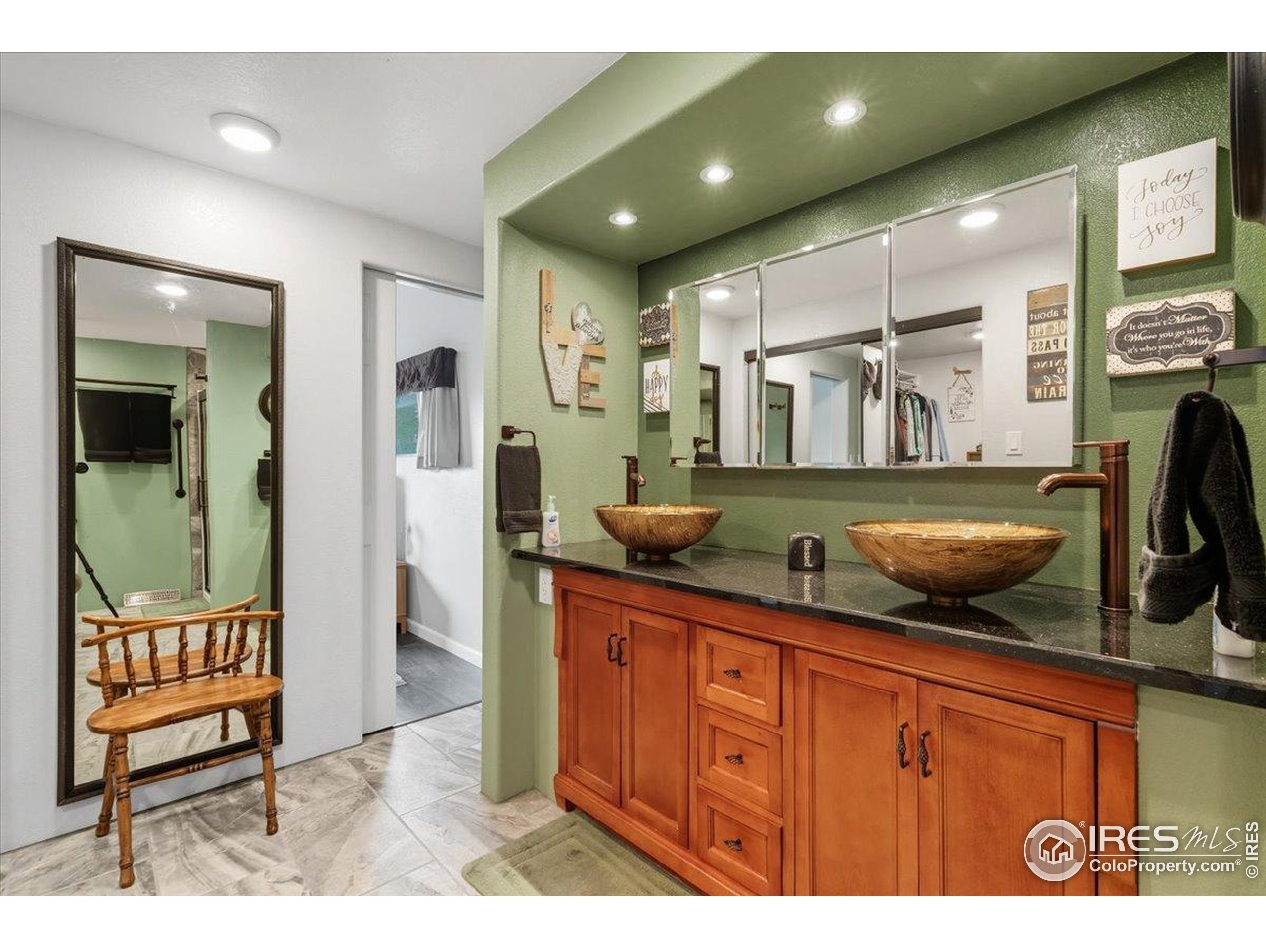 7133 North Co Road 19 Fort Collins, CO 80524 - Photo 29 of 50 a bathroom with a sink a mirror and glass door