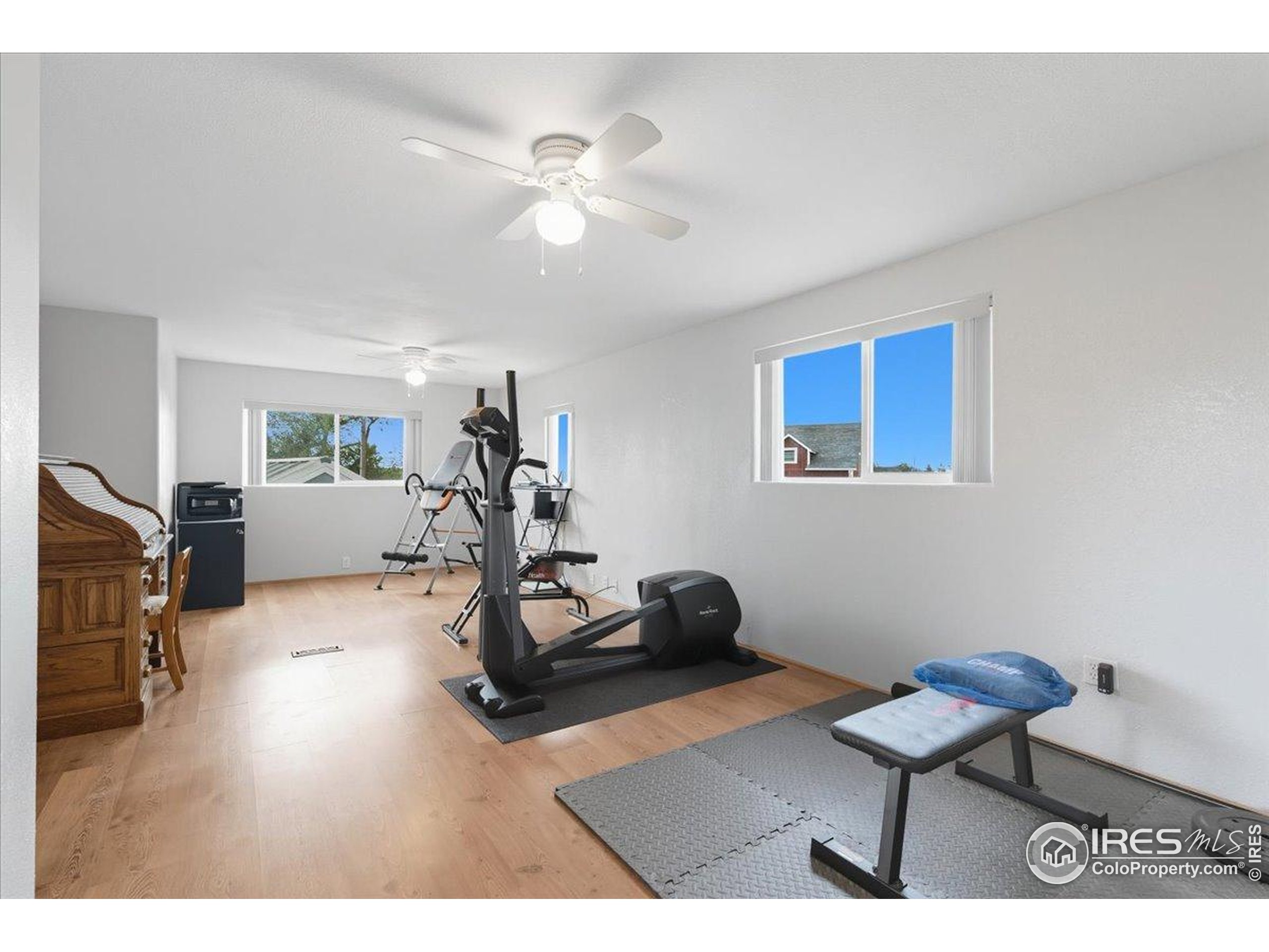 7133 North Co Road 19 Fort Collins, CO 80524 - Photo 32 of 50 a room with furniture and a wooden floor