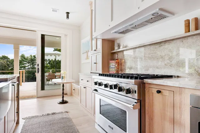 a kitchen with a stove a washer and dryer next to a window