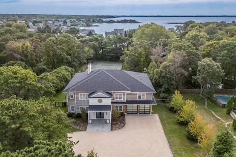 an aerial view of a house with swimming pool and sitting area