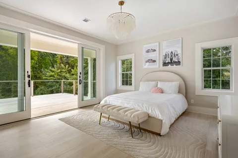 a bedroom with a large bed and a large window