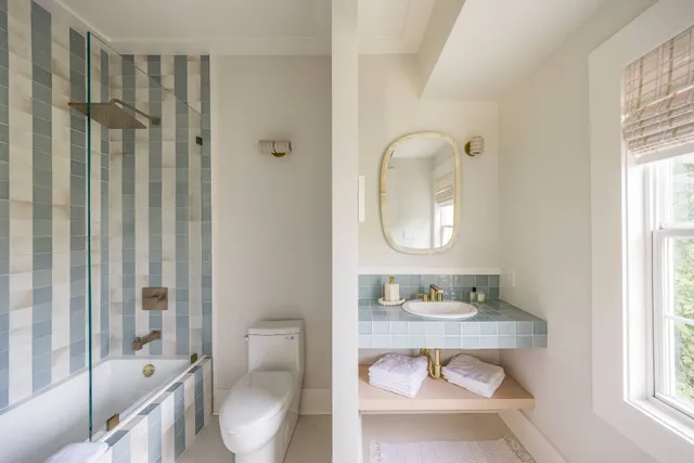 a bathroom with a toilet a sink and a mirror