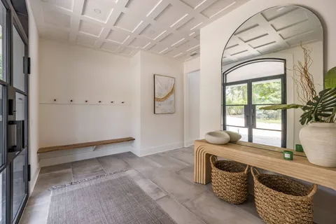 a view of an entryway with wooden floor