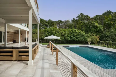 a view of a patio with chairs and a yard