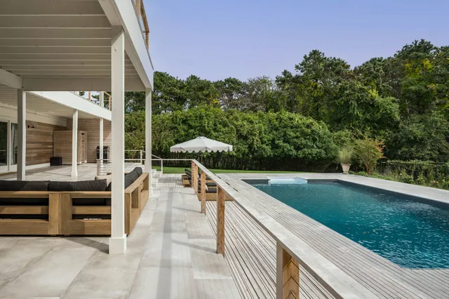 a view of a patio with chairs and a yard