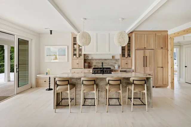a large kitchen with a table and chairs