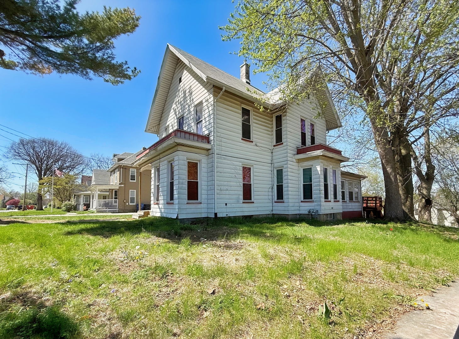 1155 12th Avenue Moline, IL 61265 - Photo 3 of 18 a view of a white house with a large pool and large trees