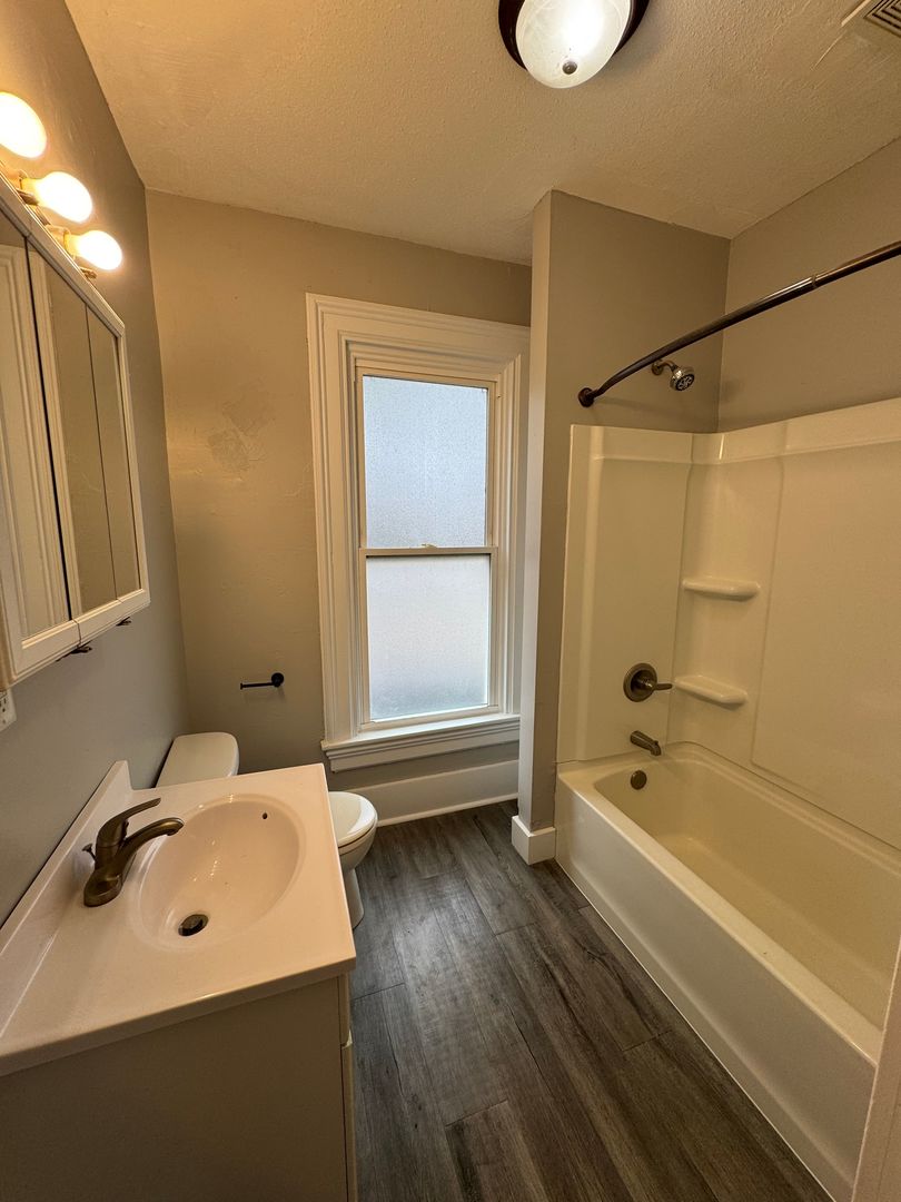 1155 12th Avenue Moline, IL 61265 - Photo 10 of 18 a bathroom with a sink a toilet and shower